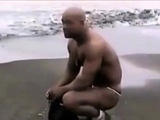 Asian bodybuilder barely covered at the beach