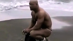 Asian bodybuilder barely covered at the beach