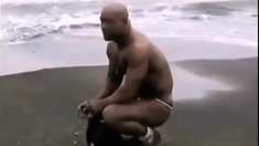 Asian bodybuilder barely covered at the beach