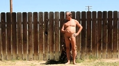 A daddy parading around naked in his backyard.